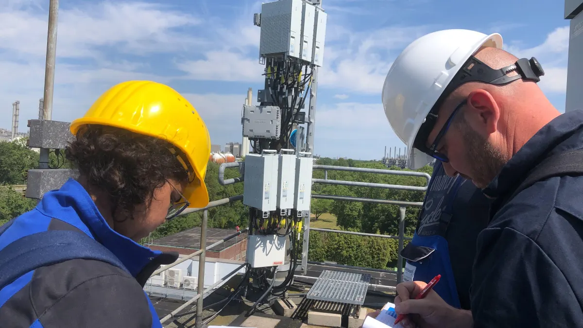 Crew commissioning rooftop radios at a refinery